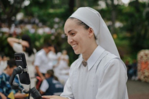 One Young Nun Serves God with a Dental Drill and a Smartphone